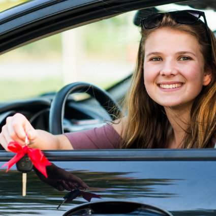 A girl in a car with Keys in her hand